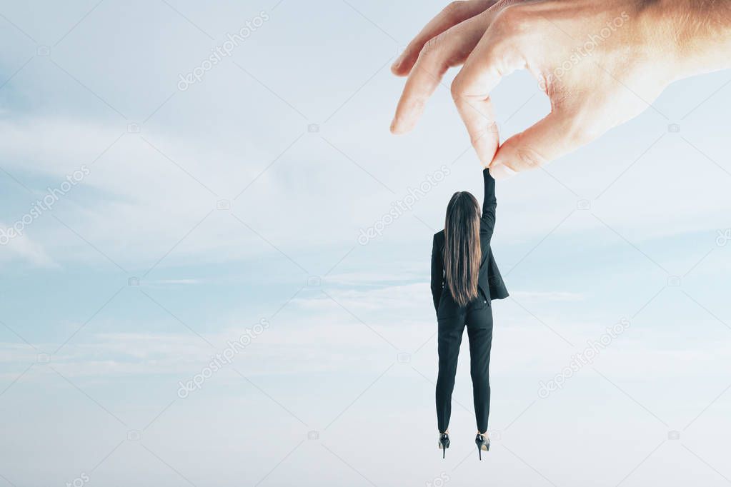 Teamwork and supervision concept. Hand holding businesswoman on sky background