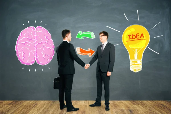 Attractive European Businessmen Shaking Hands Chalkboard Background Drawn Brain Lamp — Stock Photo, Image