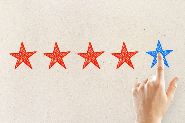 Hands with five star rating on light background. Ranking and exellence concept