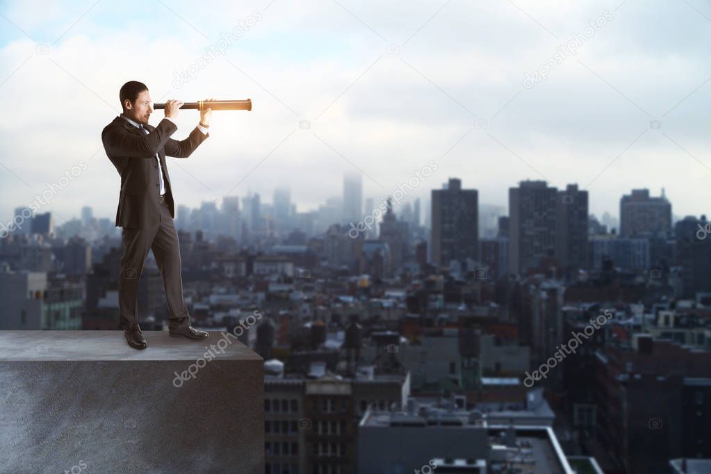 Side view of young businessman looking into the distance with telescope on sky background with copy space. Vision and challenge concept 