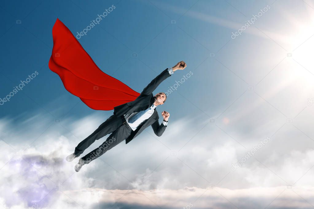 Flying businessman hero on sky background. Success and leadership concept 