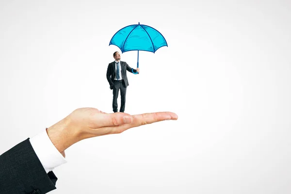 Hand Holding Businessman Drawn Umbrella White Background Protection Safety Concept — Stock Photo, Image