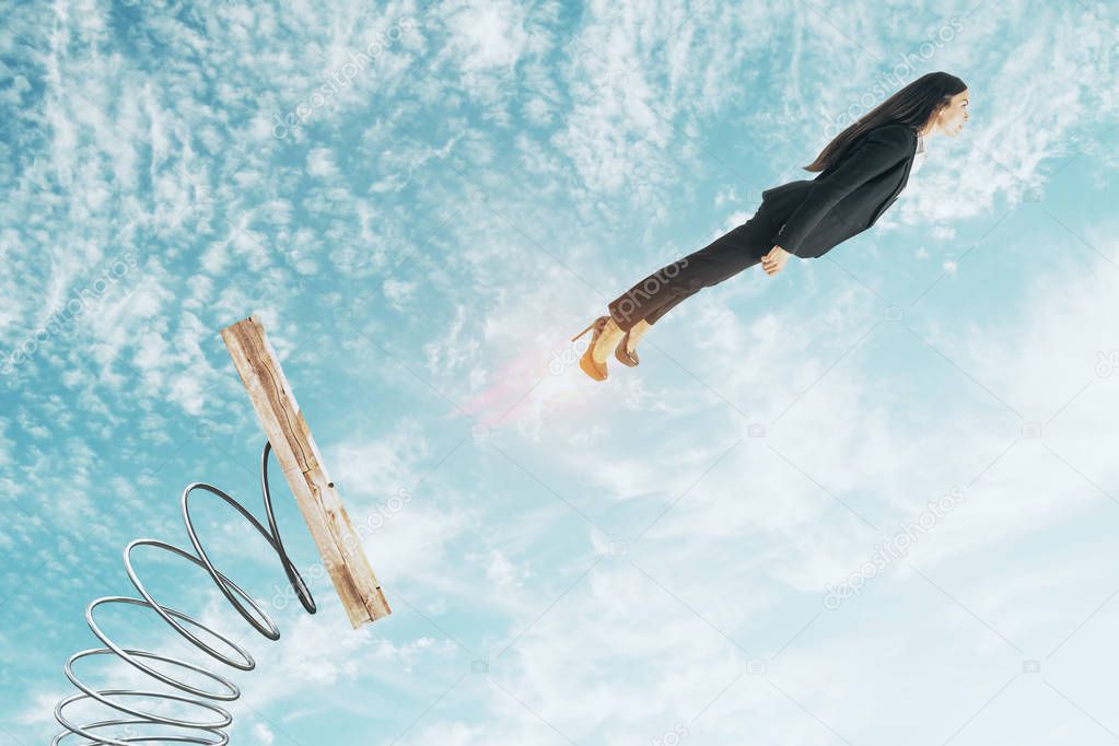 Businesswoman lauching off big spring on sky background with clouds. Startup and confidence concept 