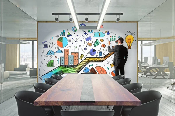 Businessman in modern meeting room with creative business sketch on whiteboard. Marketing and presentation concept.