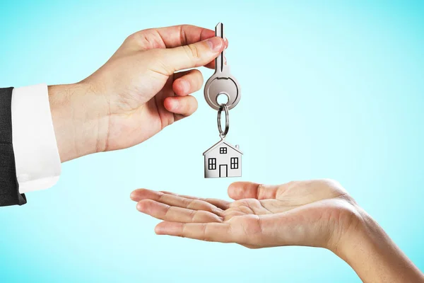 Businessman Handing Key Blue Background Mortgage House Concept — Stock Photo, Image