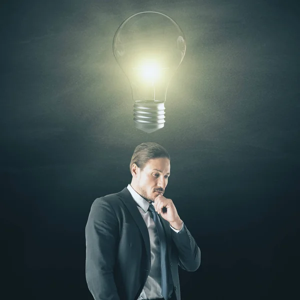 Portrait Attractive Young Businessman Lamp Dark Background Idea Solution Concept — Stock Photo, Image