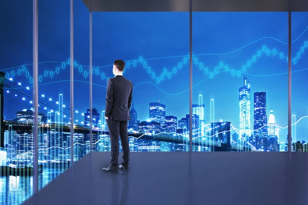 Trade and market concept. Businessman in interior with night NYC view and forex chart. Double exposure