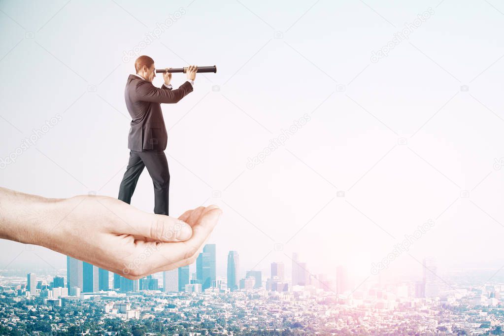 Research and success concept. Hand holding businessman with telescope on sky background with copy space