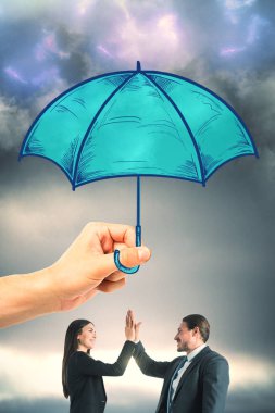 Hand holding drawn blue umbrella over businessman and woman on cloudy gray sky background. Teamwork and safety concept  clipart