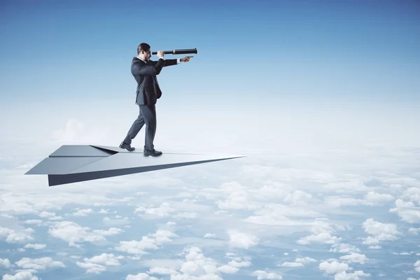 Young Businessman Using Telescope Look Distance While Standing Paper Plane — Stock Photo, Image