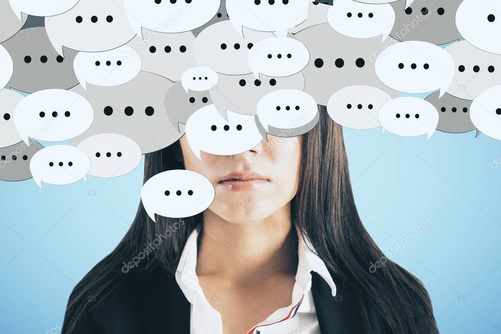 Portrait of young european businesswoman with speech bubbles. Communication concept 