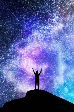 Backlit person on hill standing on beautiful starry night sky space background. Purpose and future concept  clipart