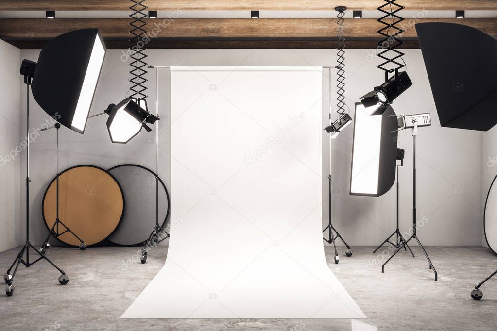 Modern photo studio interior with white background, professional equipment and concrete floor. Mock up, 3D Rendering 