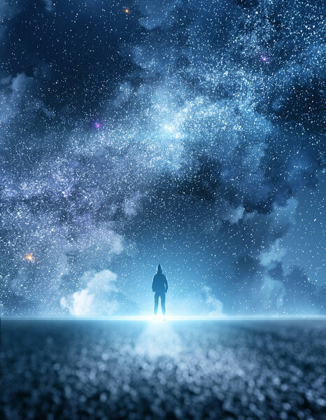 Person on road with beatiful starry night sky with clouds background. Freedom and ambition concept