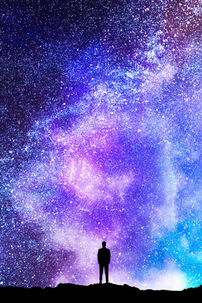 Tiny man silhouette on beautiful starry sky background. Purpose and way concept