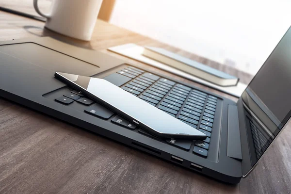 Laptop keyboard with smartphone