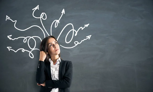 Portrait of attractive businesswoman with arrows — Stock Photo, Image