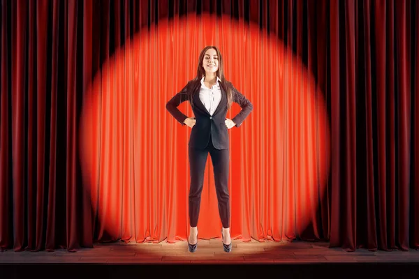 Attractive businesswoman on red stage