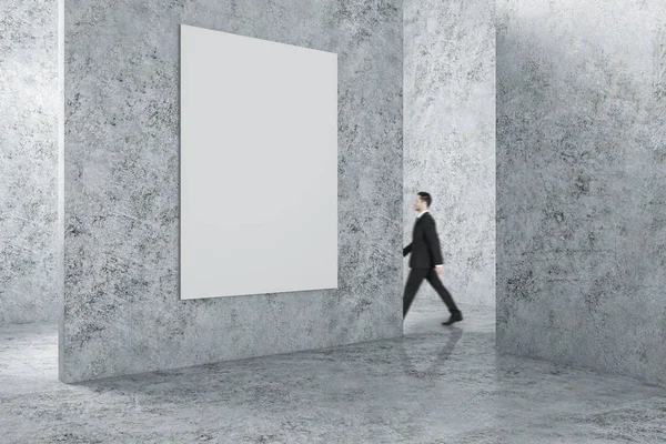 Businessman in interior with empty banner — Stock Photo, Image