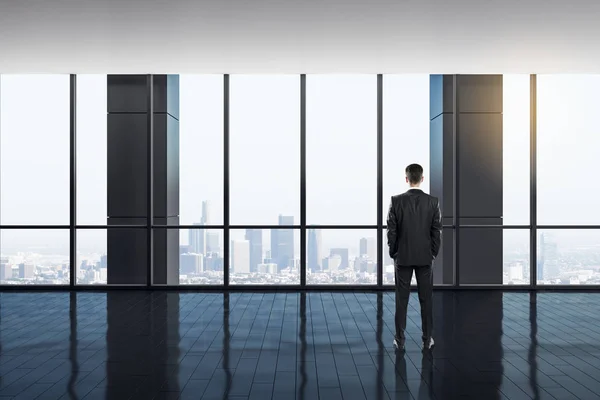 Businessman in bright office interior — Stock Photo, Image