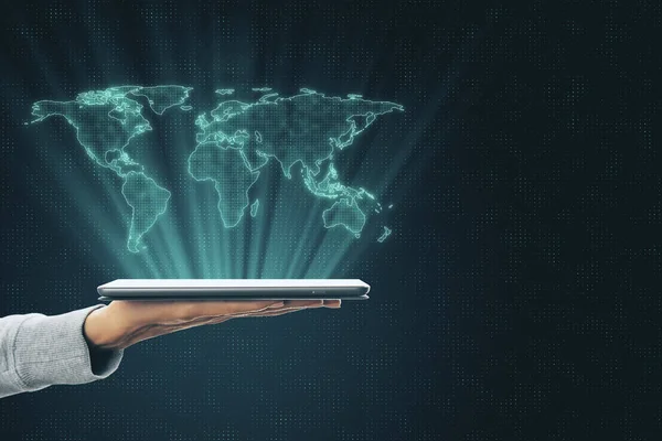 Globalization concept with digital world map layout above human hand with digital tablet.