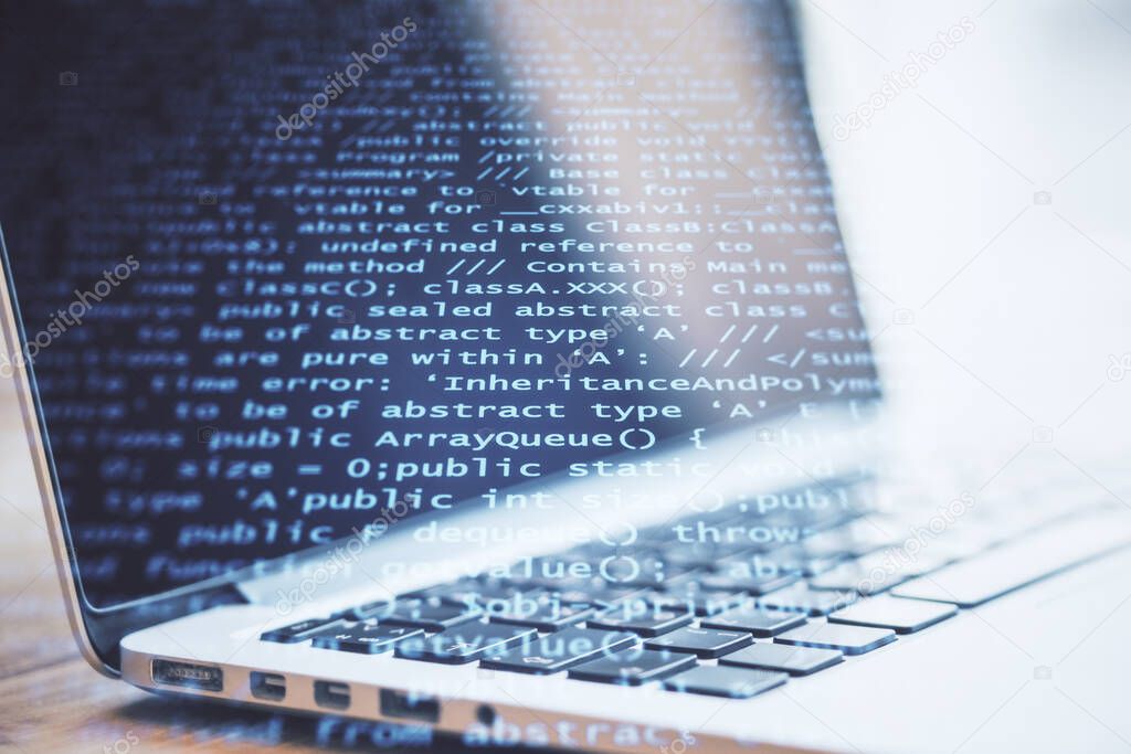 Laptop on table with abstract coding backdrop with text. Programming and future concept. Double exposure.