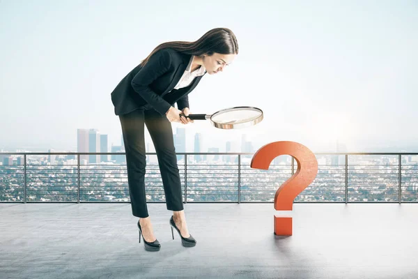 Businesswoman with magnifying glass search red question mark. Confusion and challenge concept