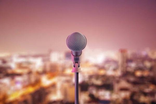 Microphone on stage on city background. Art and performance concept. 3D Rendering