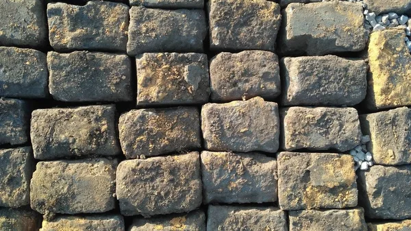 Stone pavement texture. Granite cobblestoned pavement background. Abstract background of old cobblestone pavement close-up. Prague. View from above.