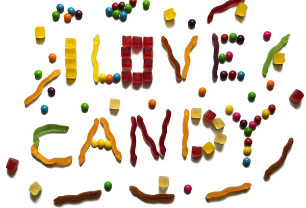 I love candy sentence made out of different colorful sweets on white background