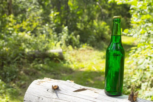 Glass transparent green glass bottle. With a cork and a bottle opener.