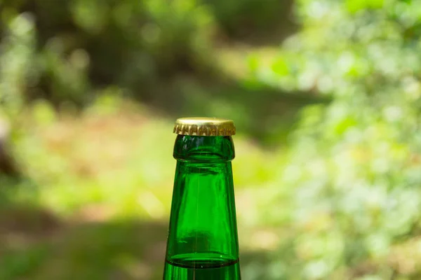 Glass transparent green glass bottle. With a cork and a bottle opener.