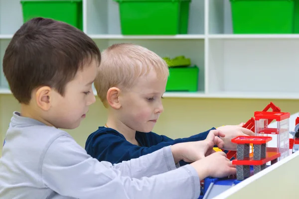 Two boys assemble a designer. Children play with toys. — Stock Photo, Image