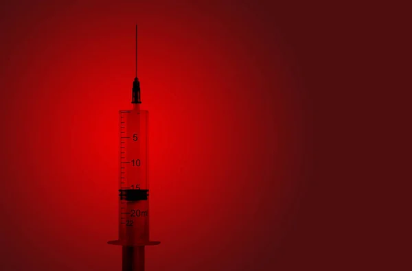 Syringe on a red background. Danger infection with AIDS. — Stock Photo, Image