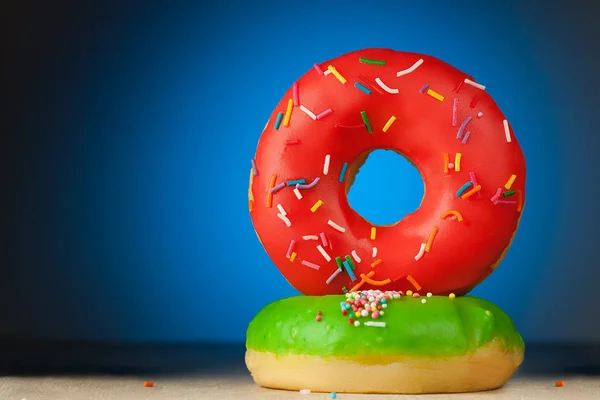 Red and green donuts on a blue background