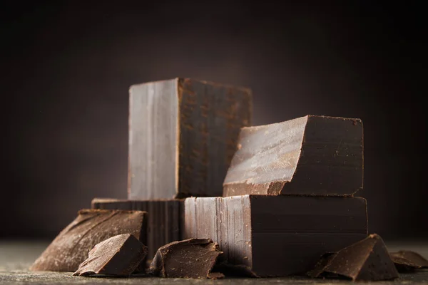 Dark chocolate on a wooden background — Stock Photo, Image