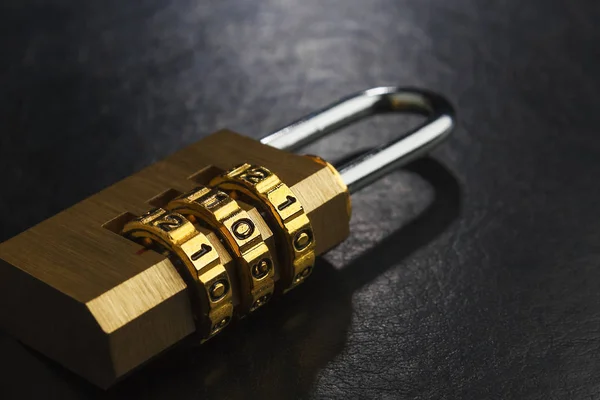 Brass lock with the code set on the dark surface — Stock Photo, Image