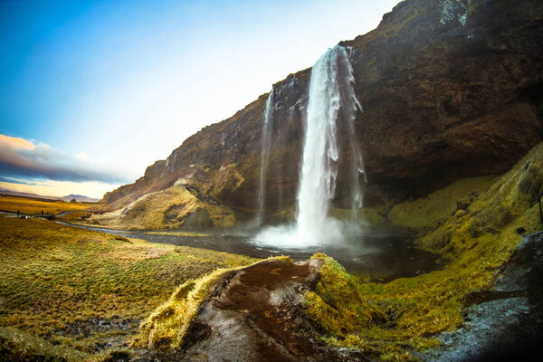 Seljalandsfoss, a waterfall with a small cave behind it in the south region in Iceland, it is part of the Seljalands River that has its origin in the volcano glacier Eyjafjallajokull