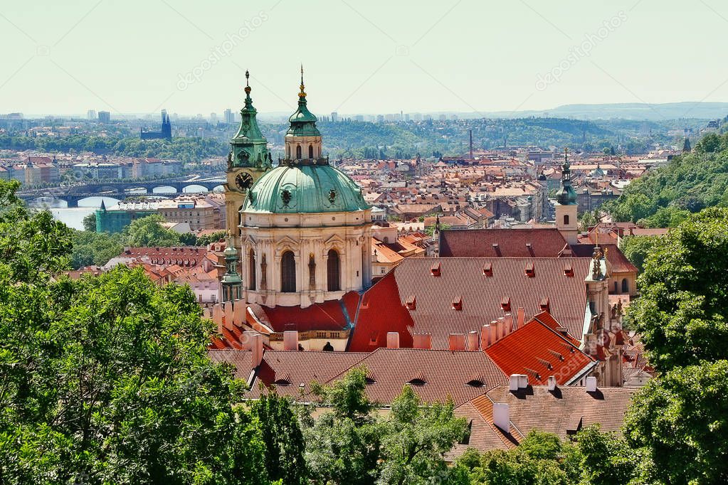 Dome and Bell tower of Saint Nicholas cathedral in scene of Vltava river and bridge in Prague city, Prague (Praha), Czech Republic (Ceska Republika), Bohemia region