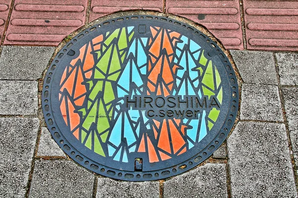 Hiroshima Prefecture, Chugoku region, Japan - September 21, 2009 - Manhole cover in Hiroshima decorated with Thousand Origami Paper Cranes ( Senbazuru) that to pray for peace and Sadako Sasaki.