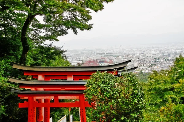 Kyoto Prefecture, Kansai, Japan - September 28, 2009 - Cityscape of Kyoto with Torii gate of Fushimi Inari Taisha (), view from Mount Inari in Fushimi-ku.