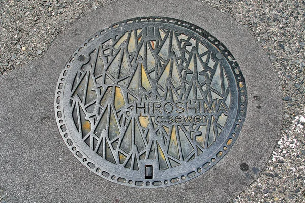 Hiroshima Prefecture, Chugoku region, Japan - September 21, 2009 - Manhole cover in Hiroshima decorated with Thousand Origami Paper Cranes ( Senbazuru) that to pray for peace and Sadako Sasaki.