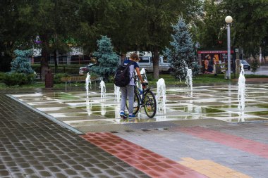 Kuru bir çeşmede bisiklet süren bir çocuk