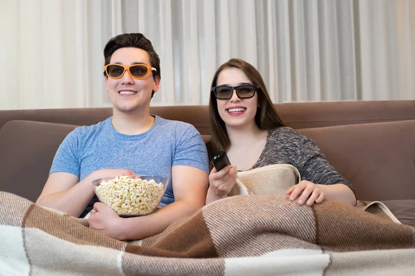 young couple handsome man and beautiful woman rooting for their favourite sports team that just scored goal both in sunglasses looking happy