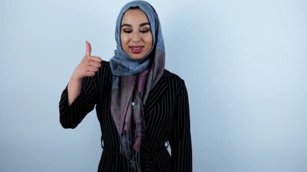 Young beautiful arabic woman holding her finder up giving like symbol on isolated white background — Stock Video