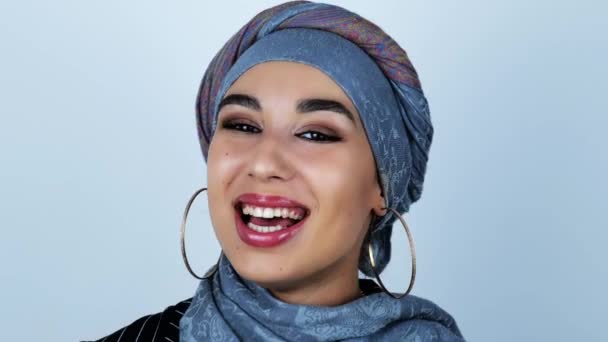 Young beautiful arabic woman feels joyful smiles on isolated white background — Stock Video
