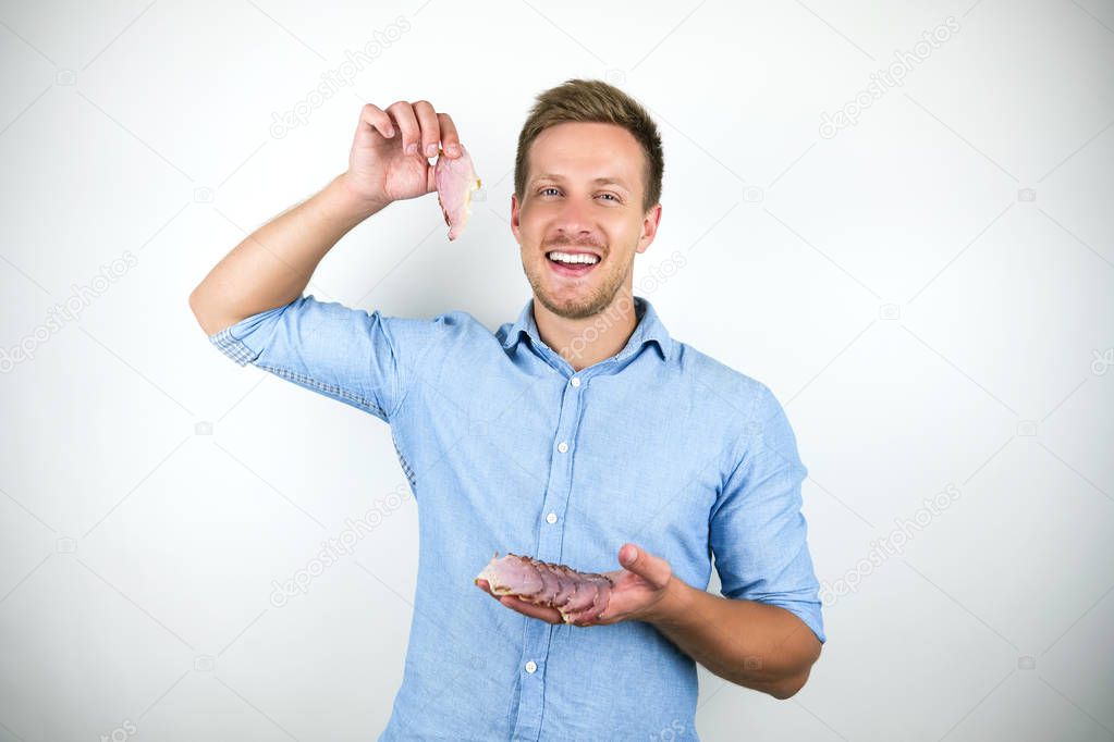 young handsome man holding bacon on isolated white background
