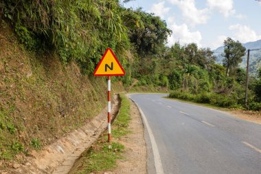 sign winding road on a mountain road, warning traffic sign Vietnam