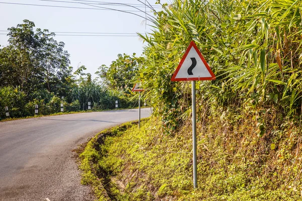 sign winding road on a mountain road, warning traffic sign Laos