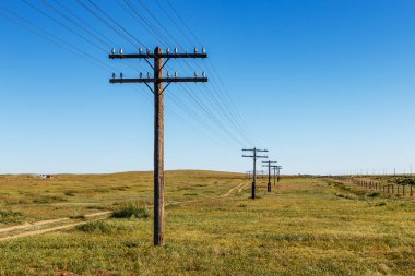 overhead line on wooden supports in the Mongolian steppe, Bayan, Mongolia clipart